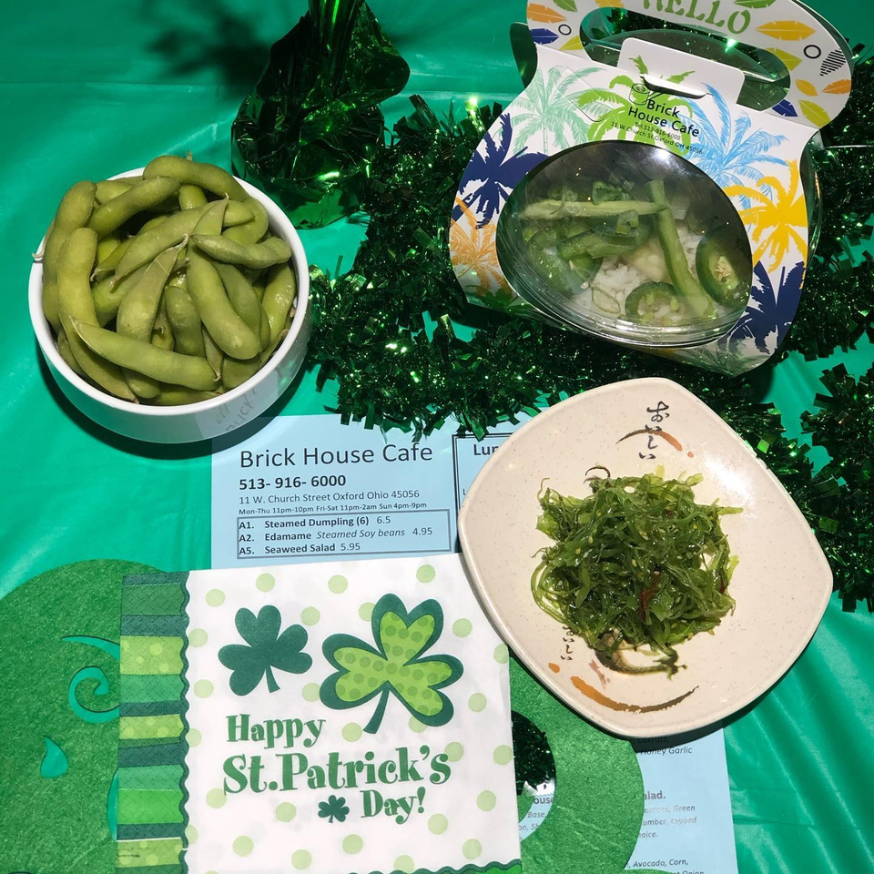 Edamame, seaweed salad, and a side salad from Brick House Cafe, with St. Patrick's Day decorations.